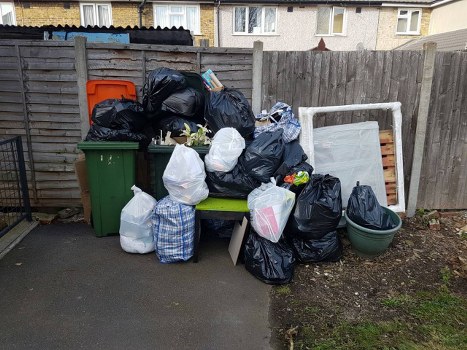 Construction site with organized waste clearance in Alperton